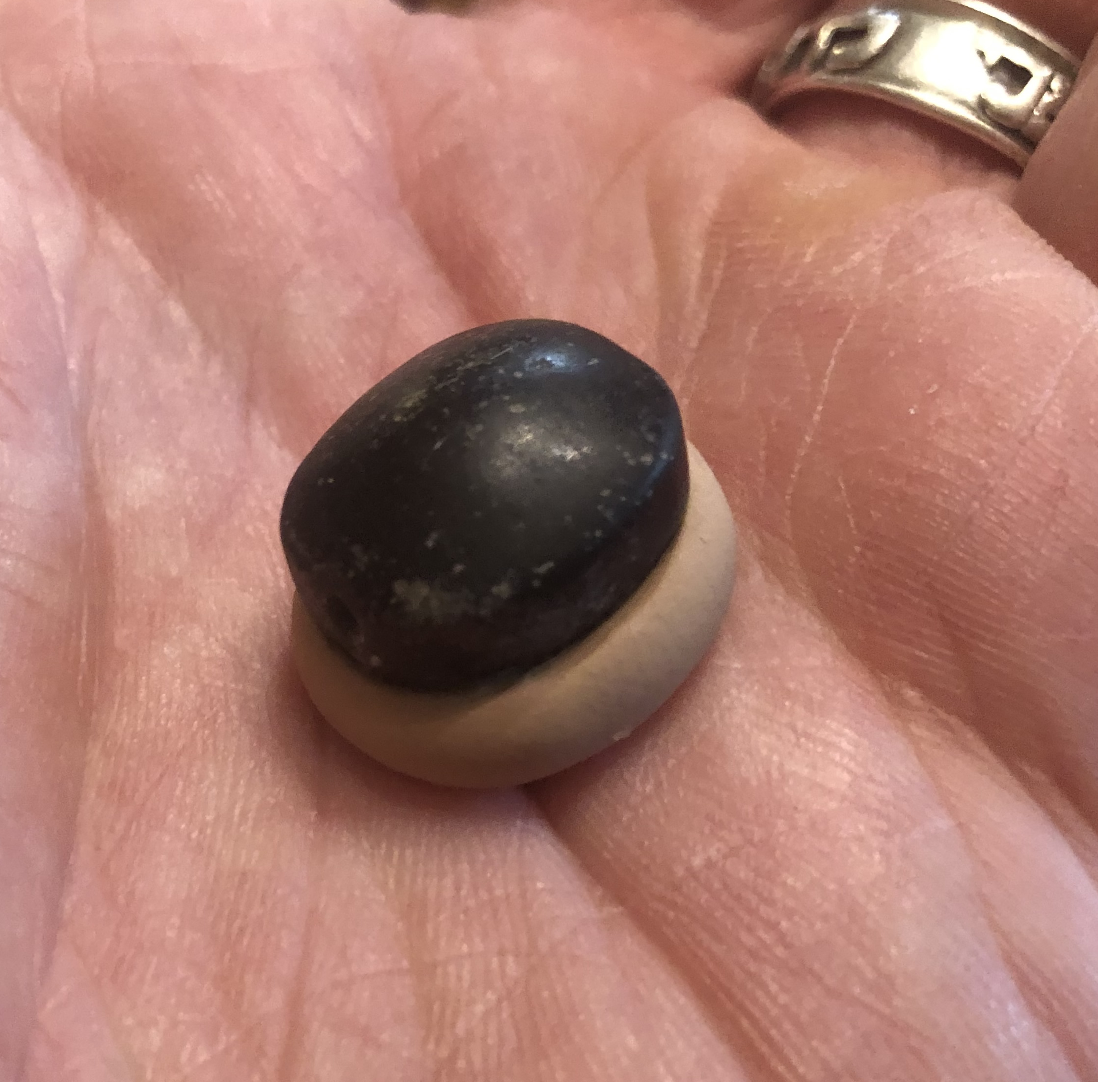 700 BC Seal in Black Hued Stone with Two Winged Sun Disc Pressing Clay Bulla